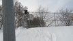 Guy Crashes Into Fence And Falls On His Back While Launching Off Of Snow Ramp