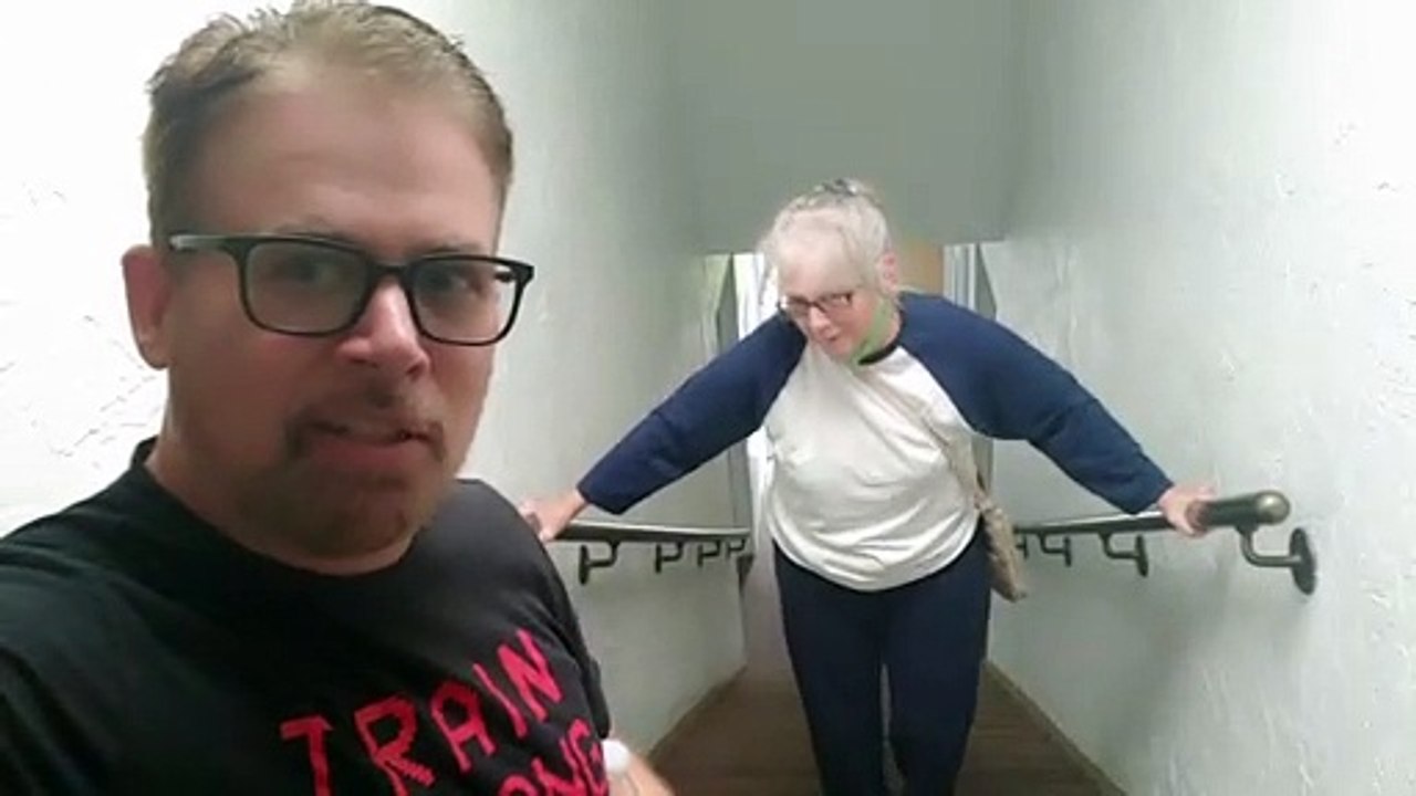 Man encourages elderly mother climbing the stairs in hilarious way