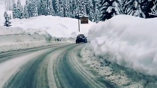 Roads cleared as snow walls tower over Washington road