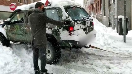 Un todoterreno Nissan Terrano remolca a un coche atrapado en la nieve.