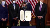 House Speaker Nancy Pelosi signs article of impeachment for Donald Trump as National Guard stand watch at Capitol