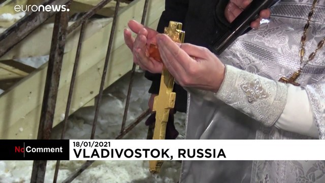 Russians submerge in frozen waters to mark Epiphany