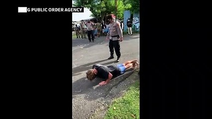 Foreigners without face masks punished with push-ups in Bali