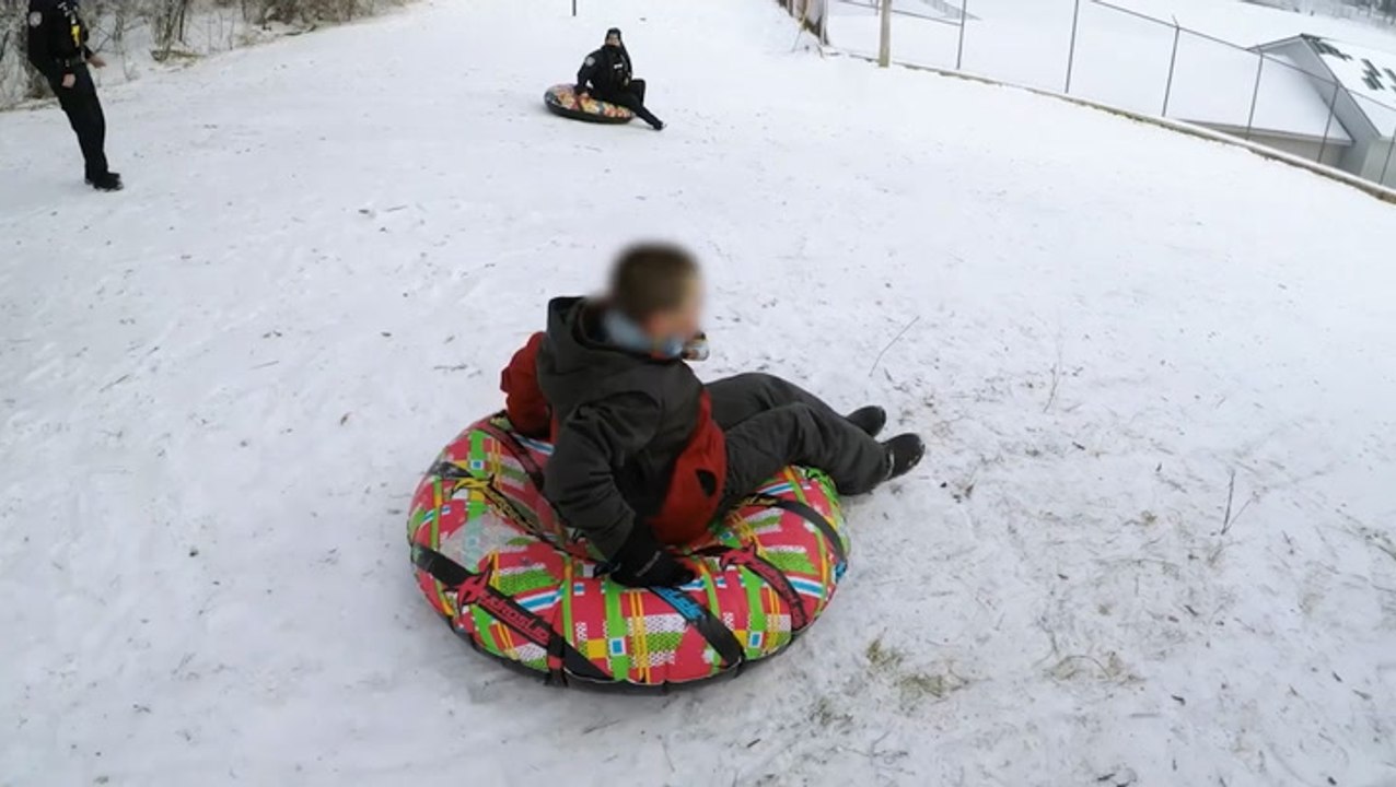Police and kids compete in friendly sled race