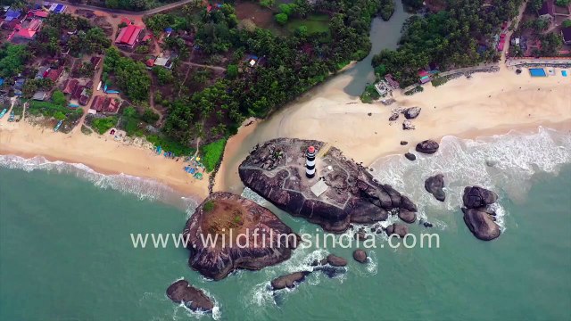 Kaup Lighthouse on huge rock on Arabian Sea shoreline in Karnataka as seen aerially