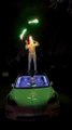 Man Juggles LED Juggling Clubs to Holiday Tunes While Standing Atop Car