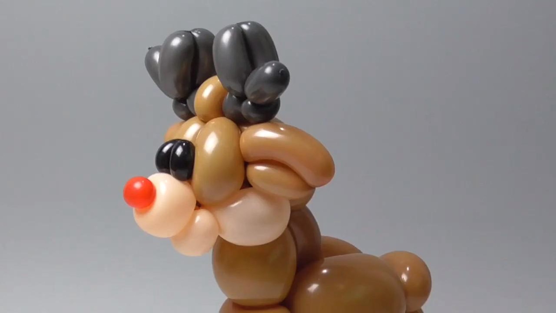 Person Makes Reindeer Balloon Sculpture