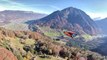 Person Does Wingsuit Base Jumping Over Scenic Landscape