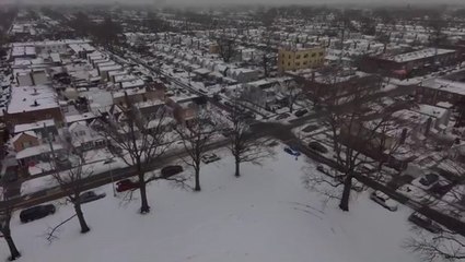 Soar over a snow-covered New York neighborhood