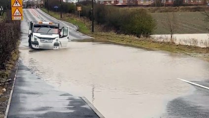 Vehicles on flooded Murton Lane
