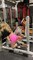 Woman Falls Off Barbell While Guy Tries to Do Squats Using Her Instead of Weights