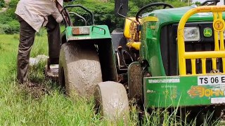 John Deere 5050D tractor stuck in mud Rescued by Massey Ferguson.