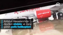 Antalya Havaalanı'nda devrilen otobüs ve zarar gören polis helikopteri