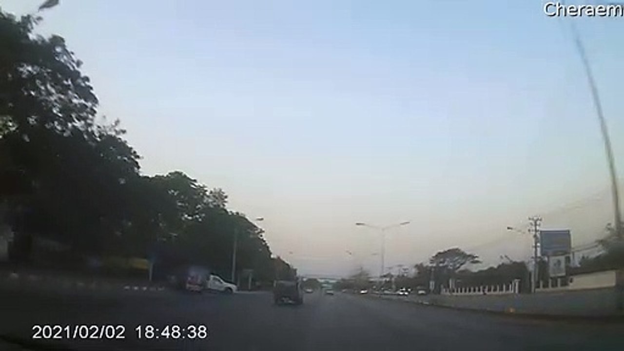 Car Rolls Through Light Post and into Traffic