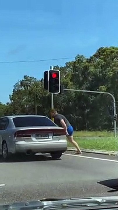 Angry Man Attacks Car at Intersection