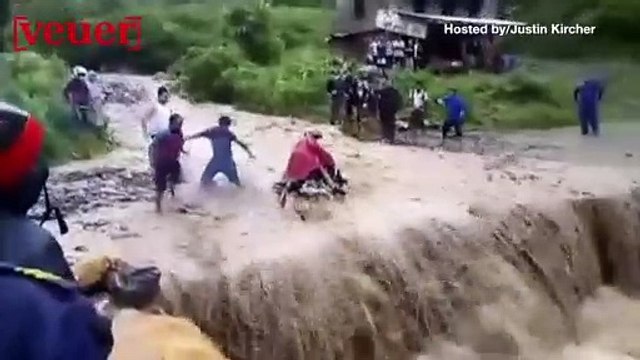 A Motorcyclist is Lucky to Be Alive After Flood Waters Swept Him Away
