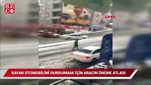 Kayan otomobilini tutmak için kendini, aracın önüne attı