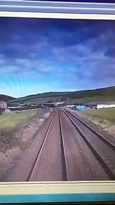 This shocking footage shows the moment an idiot driver came within seconds of being crushed by a fast-moving train after not looking both ways at a crossing