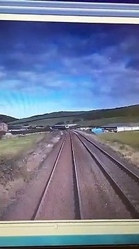 This shocking footage shows the moment an idiot driver came within seconds of being crushed by a fast-moving train after not looking both ways at a crossing