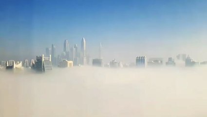 Dubai skyline hidden by thick cloud of fog