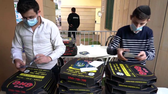 Israeli Ultra-Orthodox Jews receive pizzas after Covid vaccination