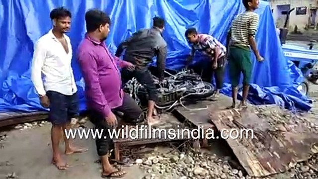 Cars and trucks destroyed in floods washed downstream in North India