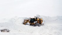 MUŞ - Kar kütlelerinin iş makinelerinin boyunu aştığı köy yolları güçlükle açılıyor