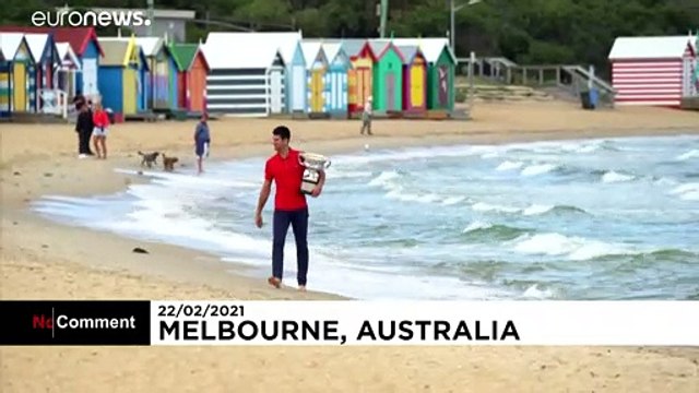 Novak Djokovic shows off trophy after Australian Open win