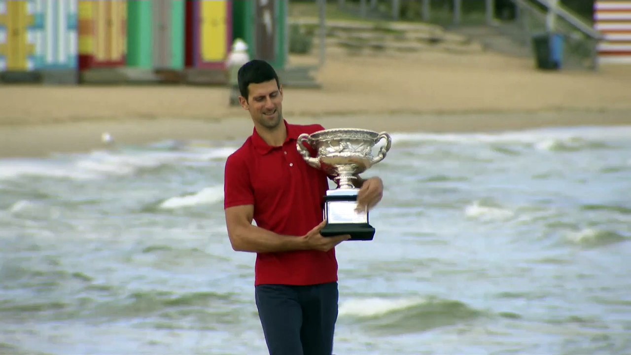 Barefoot Djokovic strolls along beach with Australian Open title