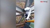 Brave train guard walks across high bridge to fix faulty train