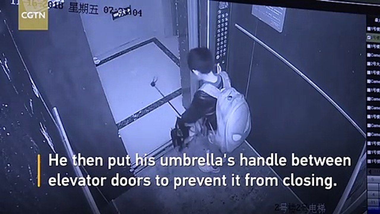 Boy uses umbrella to prevent elevator door from closing causes free fall