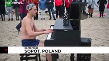 Swimsuit-clad Poles fundraise with chilly swim and beach piano tunes