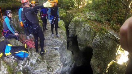 A man falls into water in a canyon
