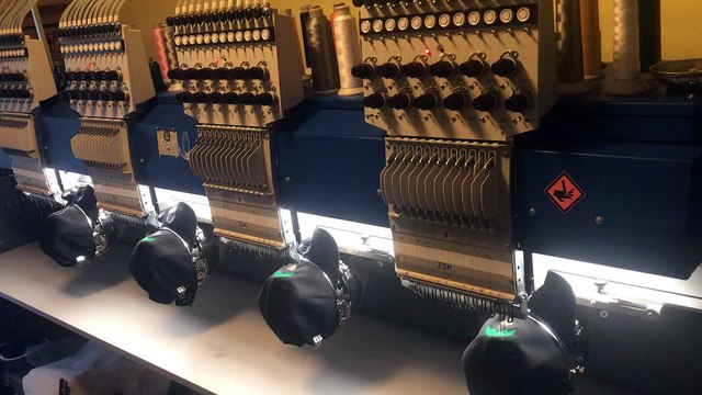 Sew N Stitches embroidering cap for a baseball tournament