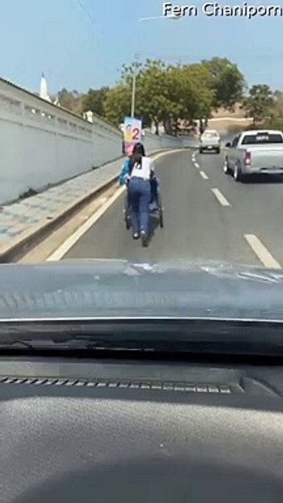 Kind Stranger Helps Person in Wheelchair up Busy Road