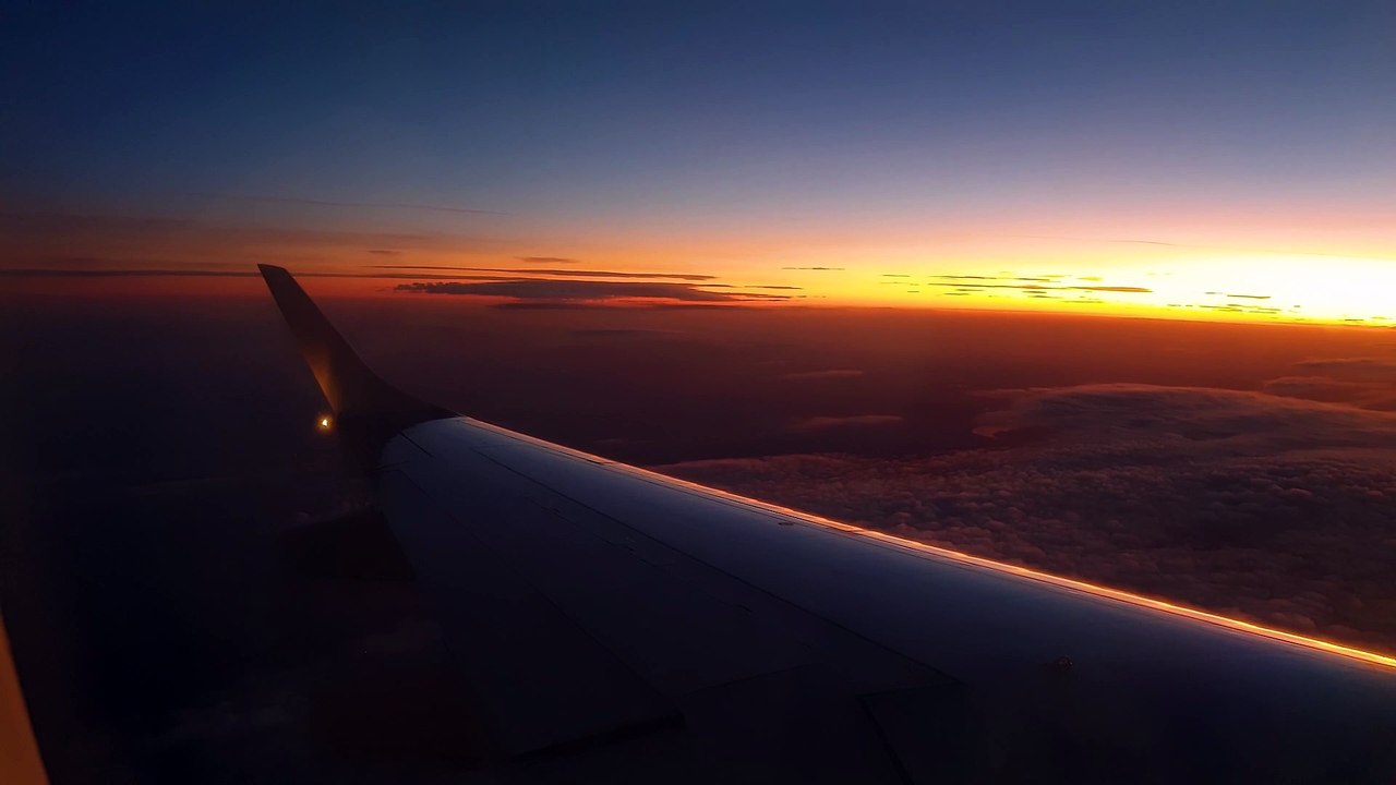 The Left Wing Of An Airborne Airplane