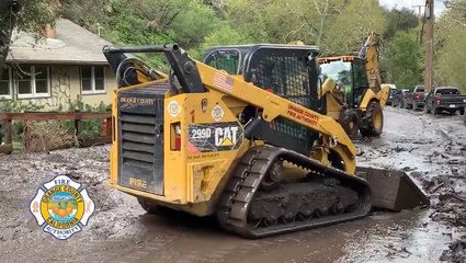 Construction vehicles get to work cleaning up mudslide