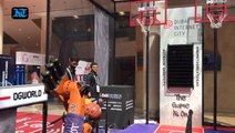 Robots and visitors shoot hoops  side by side at Gitex Tech Week