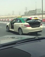 Dubai cabbie drives with broken door in boot