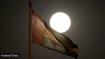 Supermoon rises behind UAE National Flag