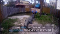Terrifying moment a man kisses an alligator