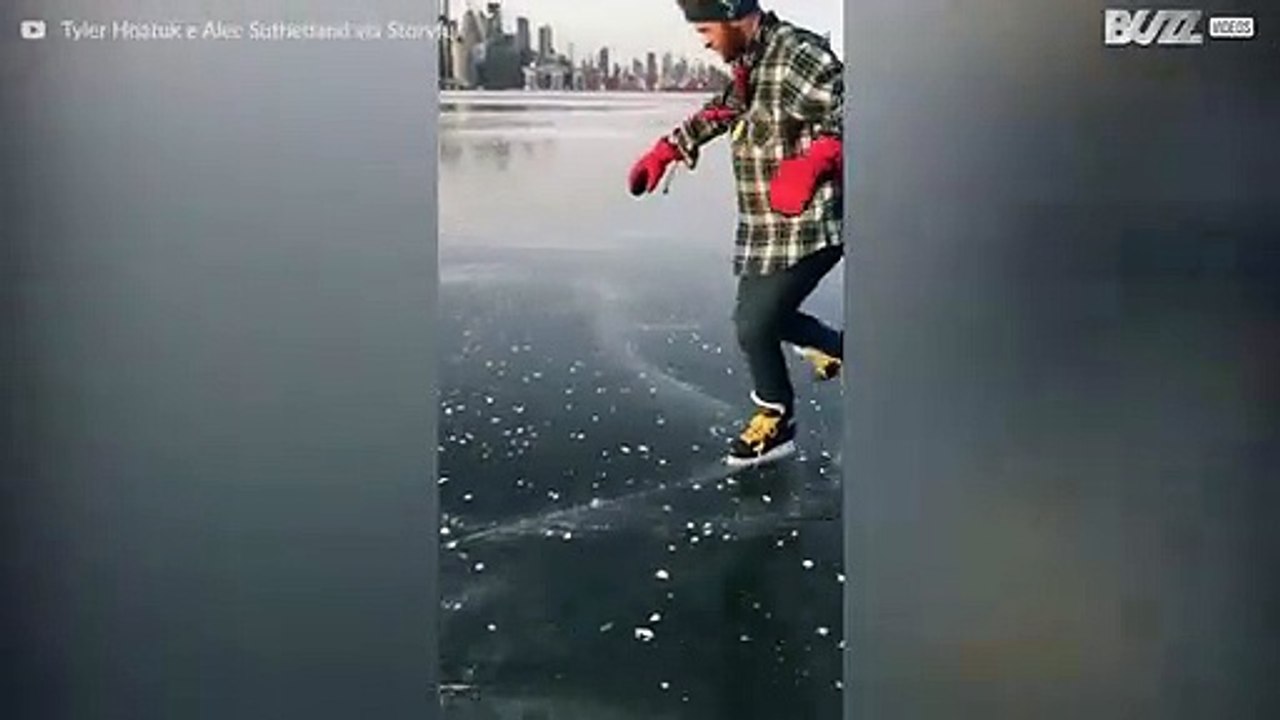 Man performs ice skating tricks on frozen Toronto lake