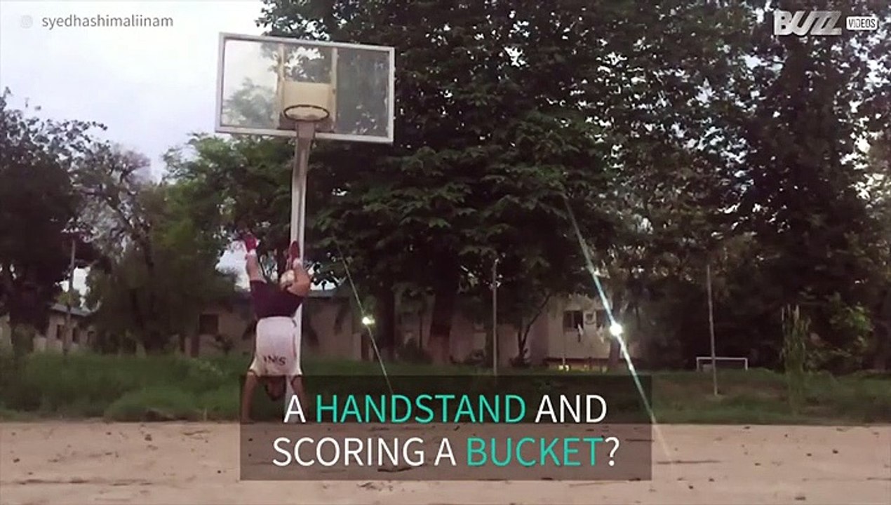 Man scores a bucket while doing a handstand