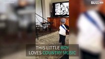 Adorable little boy loves country music