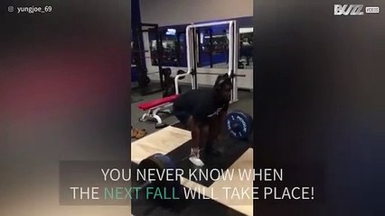 Muscleman trips while throwing his weight in gym!