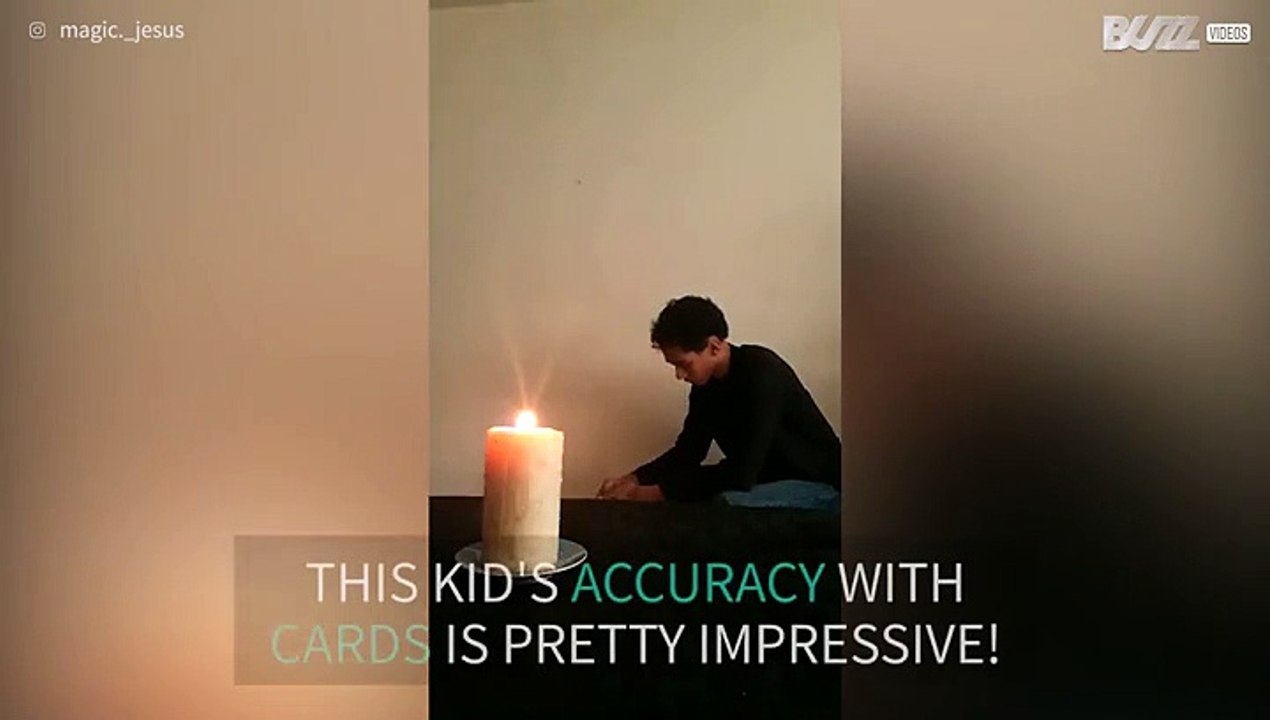 Kid extinguishes candle by throwing cards