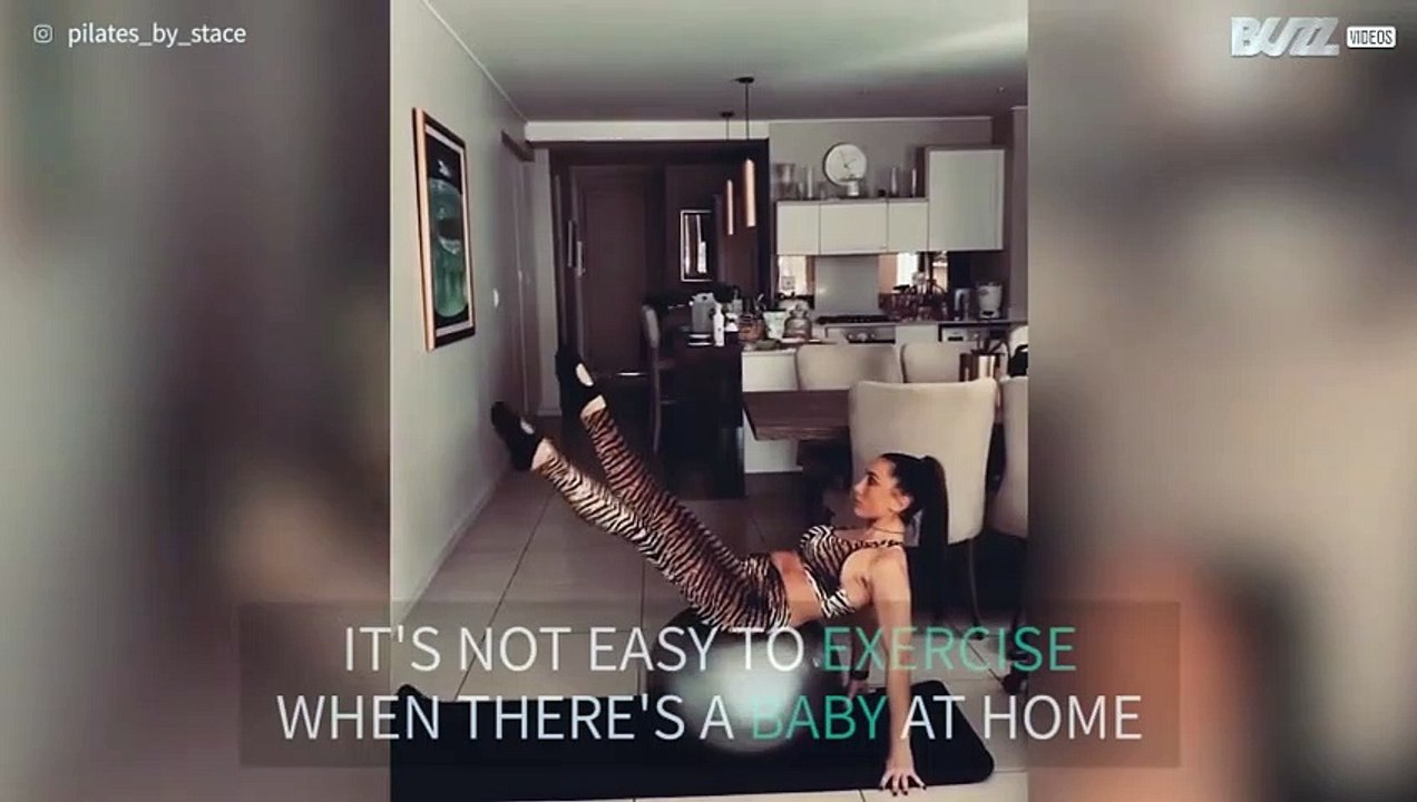 Baby interrupts mom's pilates session
