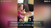 Tenera bambina legge una fiaba al suo gatto per farlo addormentare!