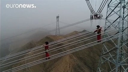 Workers make final checks on Chinas new power line