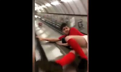 Darts fan slides down London Tube escalator